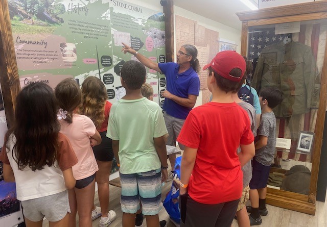 Docent with campers at the museum